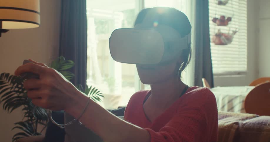 The woman points the controller in front of her