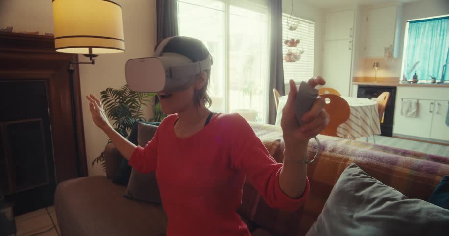 Woman plays with a vr headset in her living room