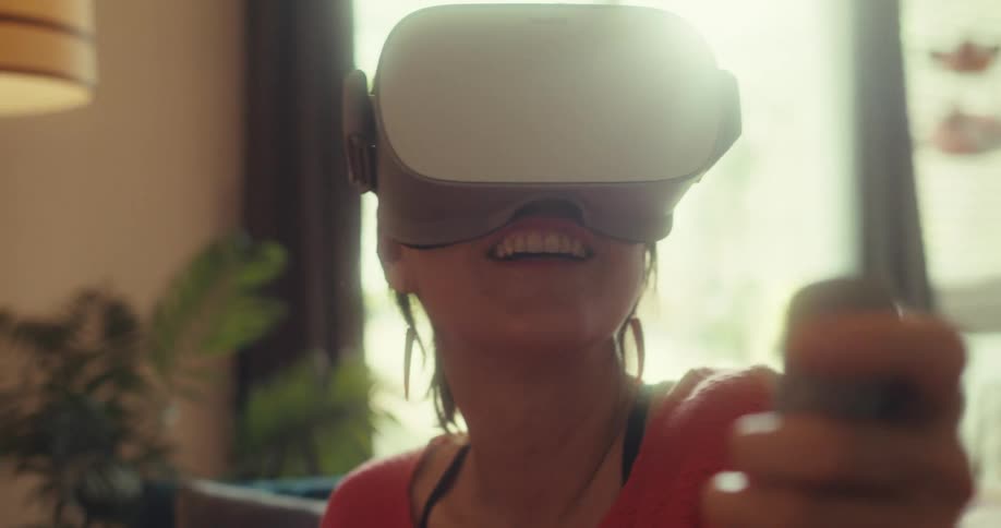 The face of a woman who is happy wearing virtual reality glasses on her head