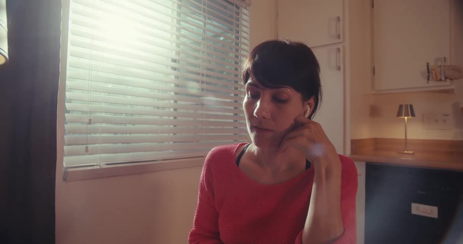 The woman frowns and shakes her head