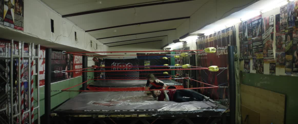 Two people fighting in a boxing ring