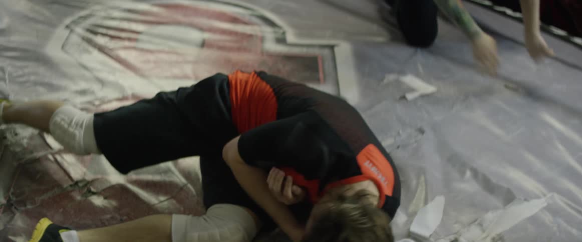 Two people are wrestling in a ring