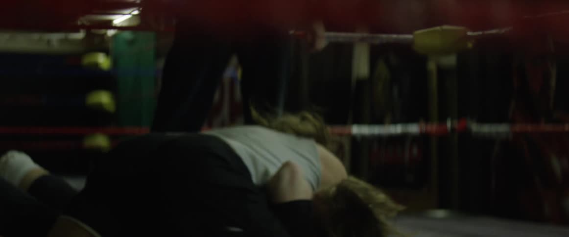 Two men wrestling in a ring