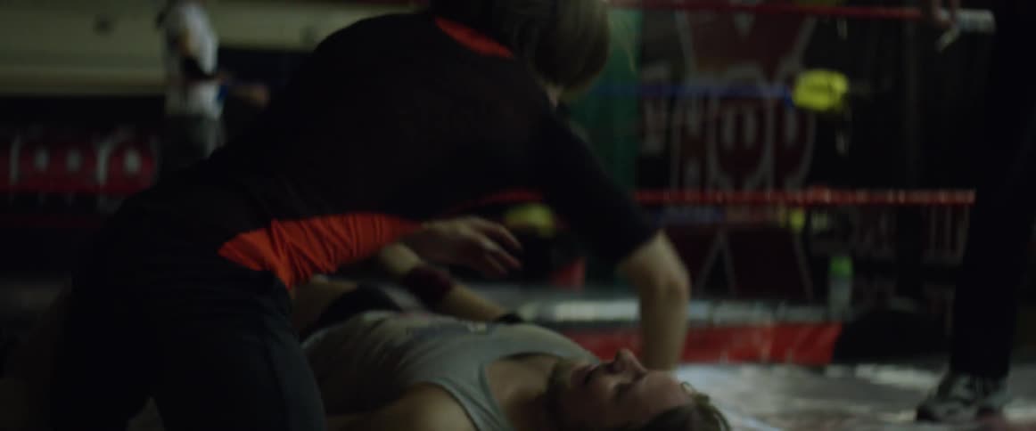 Two people are doing flips wrestling in a ring