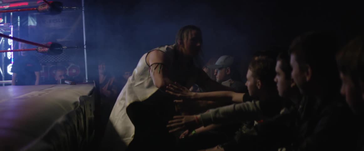 A wrestler greets the fans in the audience