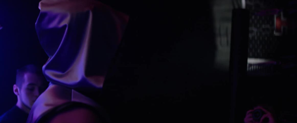 A person covered in a purple robe moving around and the lights flashing