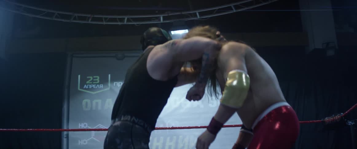 Two wrestlers are punching each other in the ring