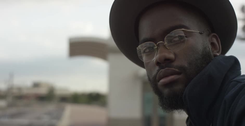 Close up of a man with glasses and hat