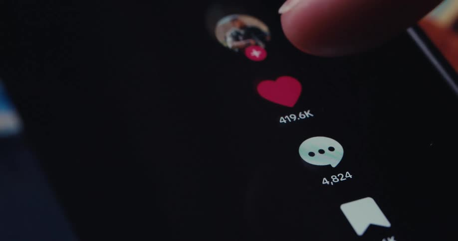 A finger taps an icon on a phone