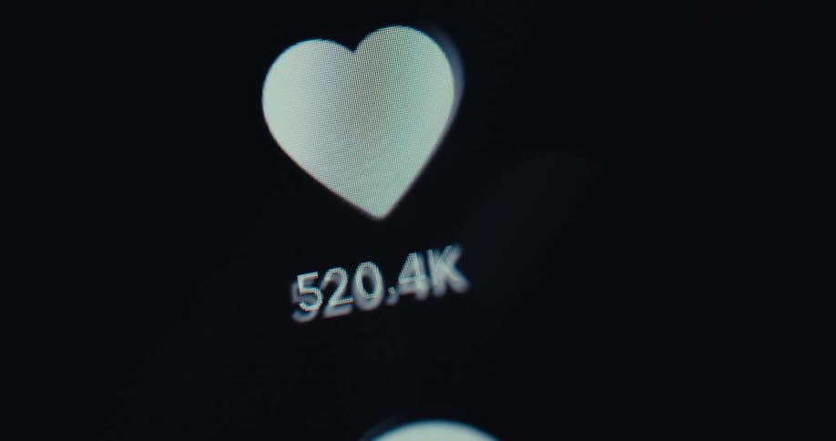 Person uses their finger to scroll vertically to show hearts representing likes