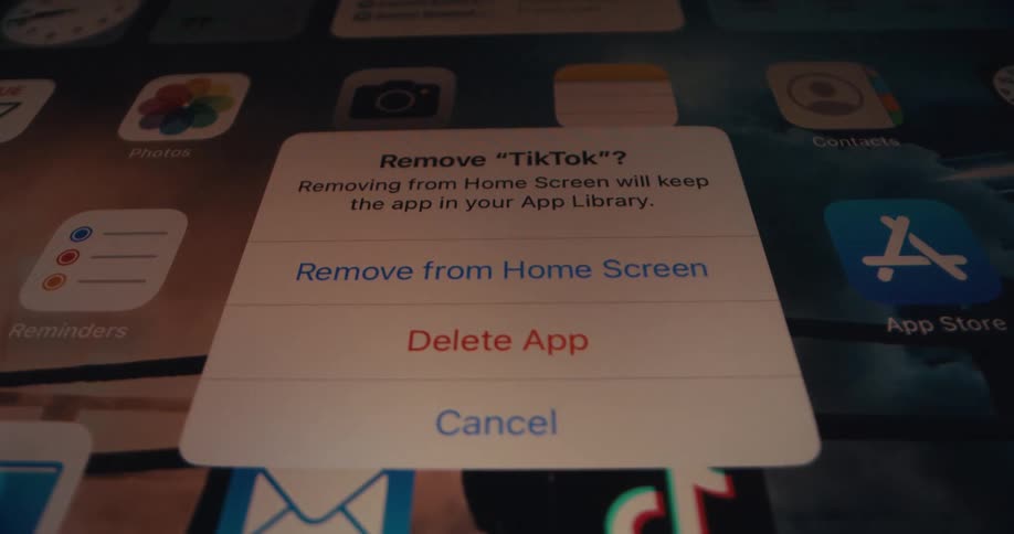 A finger hits a button on a phone screen