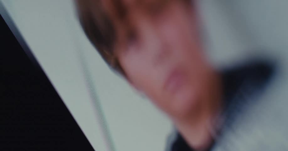 A closeup of a phone screen showing a social media feed being scrolled