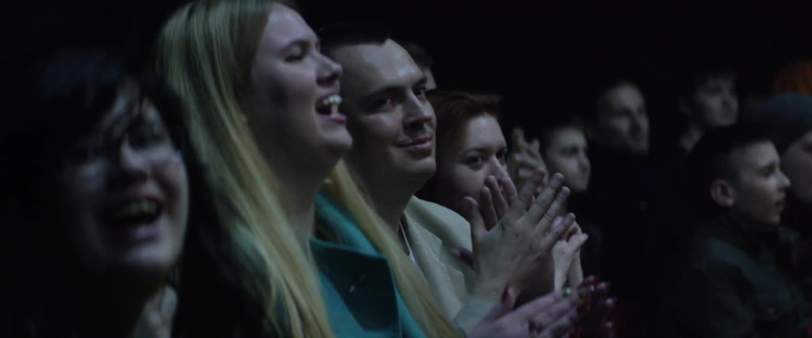 A crowd of people screaming at a concert