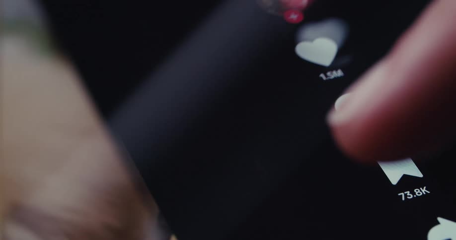 A finger tapping at a phone screen