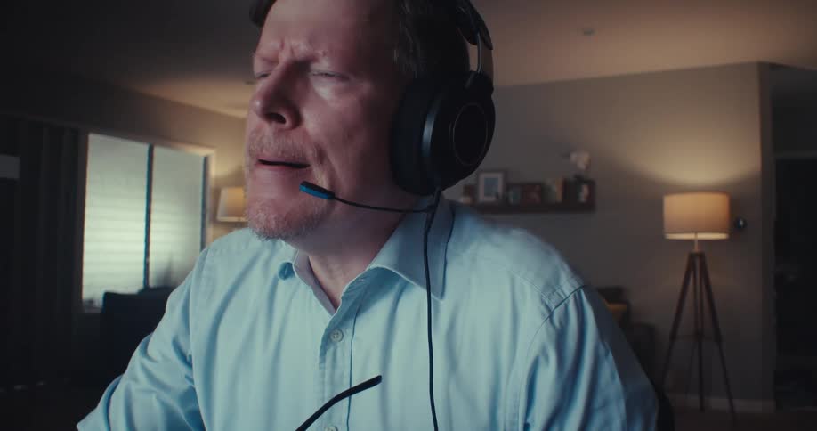 A man takes off his glasses while in deep thought
