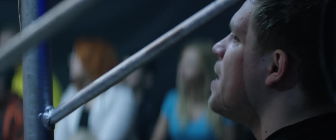A man outside a ring yelling at someone in a ring