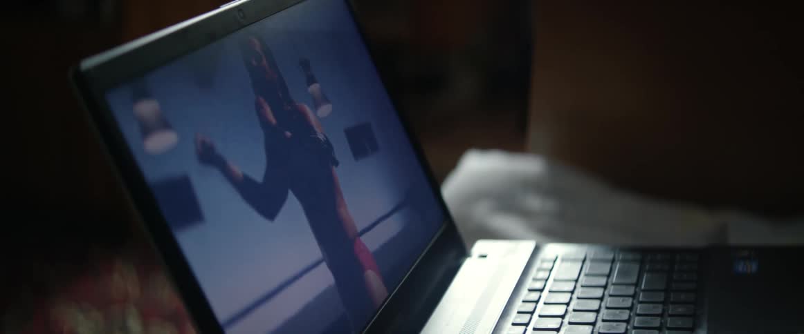 Wrestler talking in a microphone in a video on a laptop