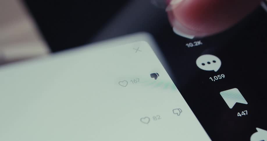 A finger taps at a phone screen