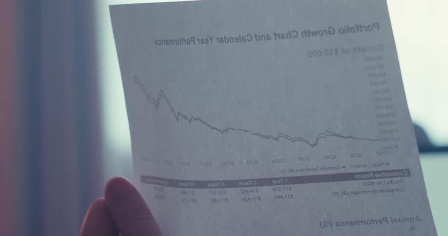 The man is holding a document in his hand