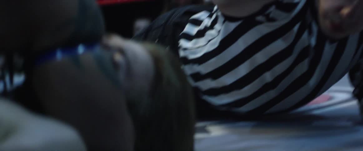Two wrestlers are laying on the ring