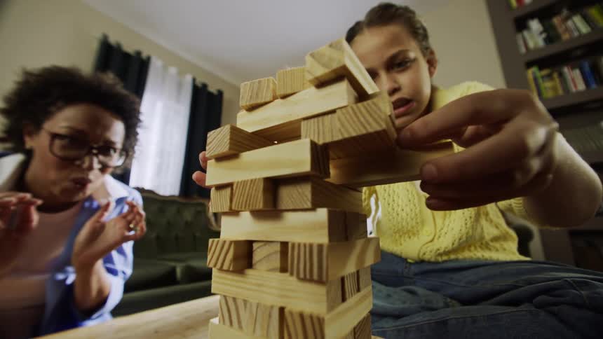 Woman and child playing a game in the living room