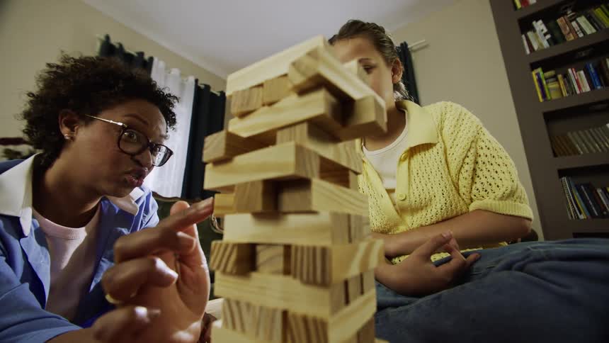 Mother and son playing jenga in thier living room