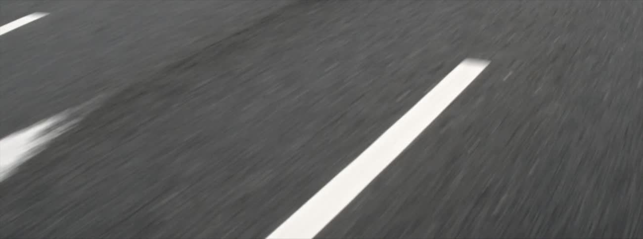 Moving down a long road marked with white lines