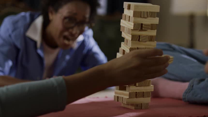 A family laugh as the blocks fall over