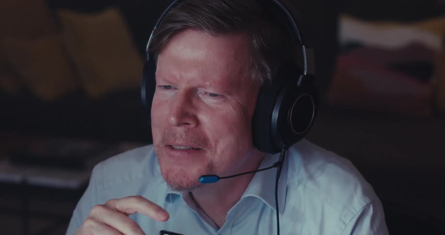 The man takes off his glasses and nods