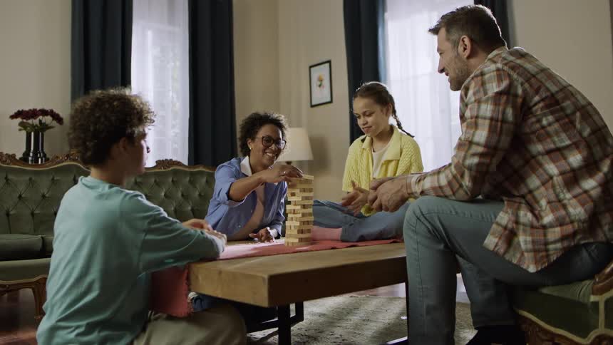 A family play a board game together