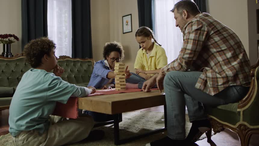Family playing a board game together in the living room