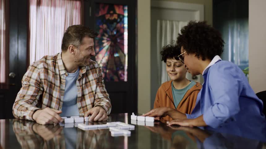 The family play dominoes together