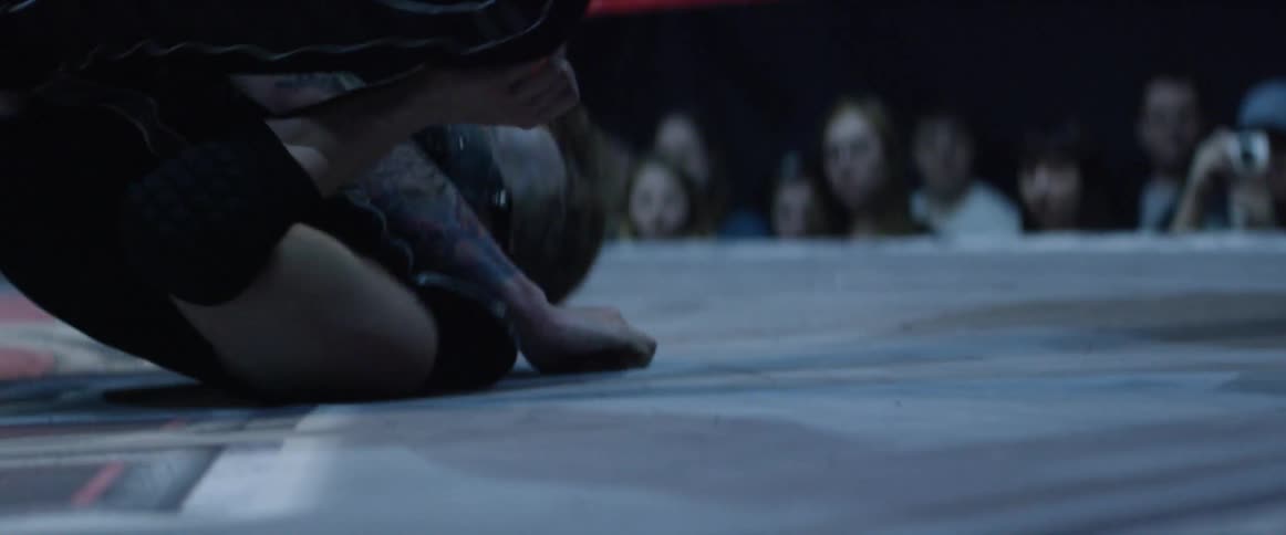 A man being picked up by another man and being slammed into the ring floor