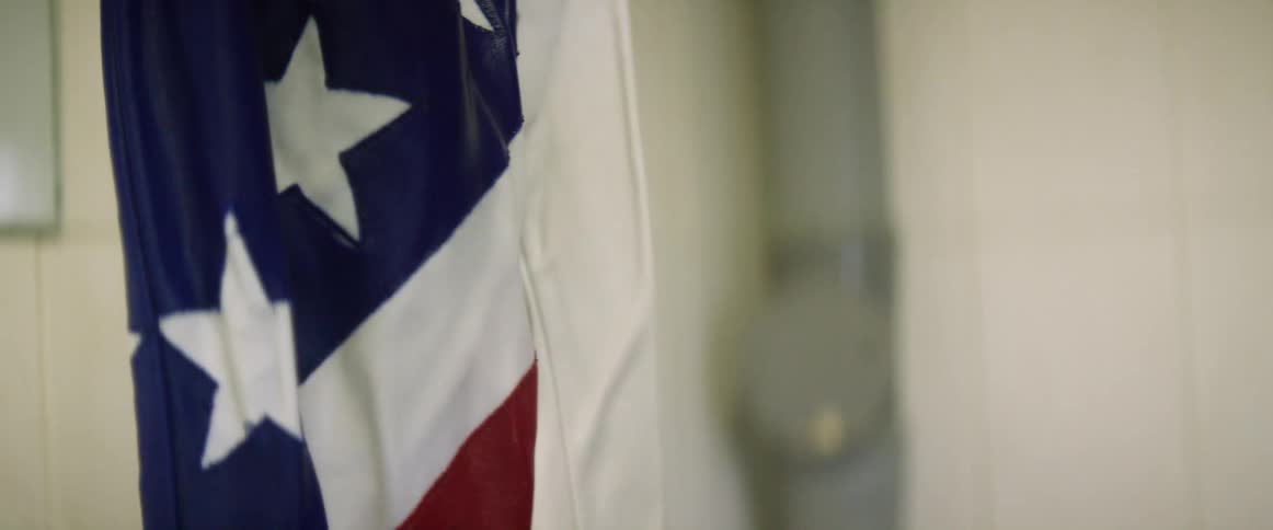 A person washes american flag pants in a tub