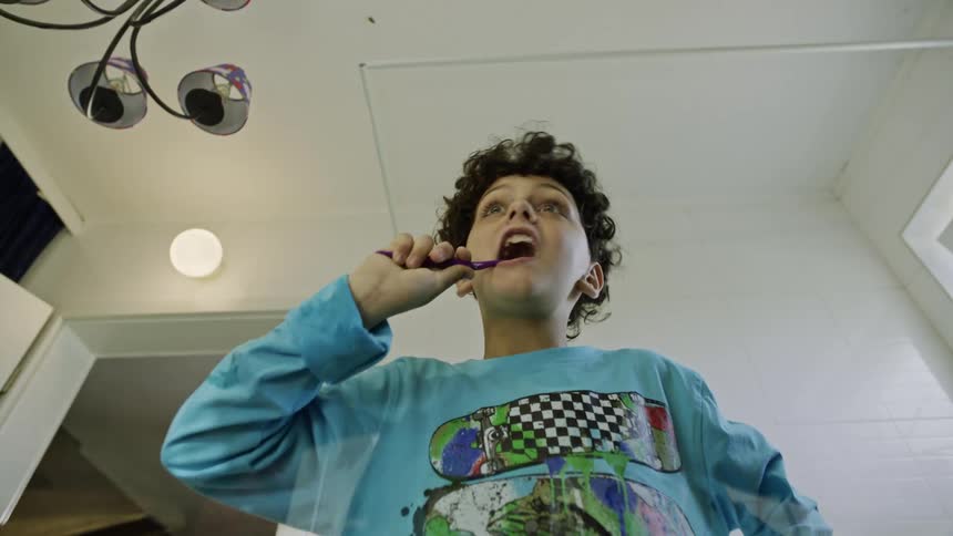 The boy brushing his teeth spits
