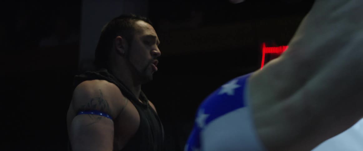 A wrestler breaths in as he gets drop kicked