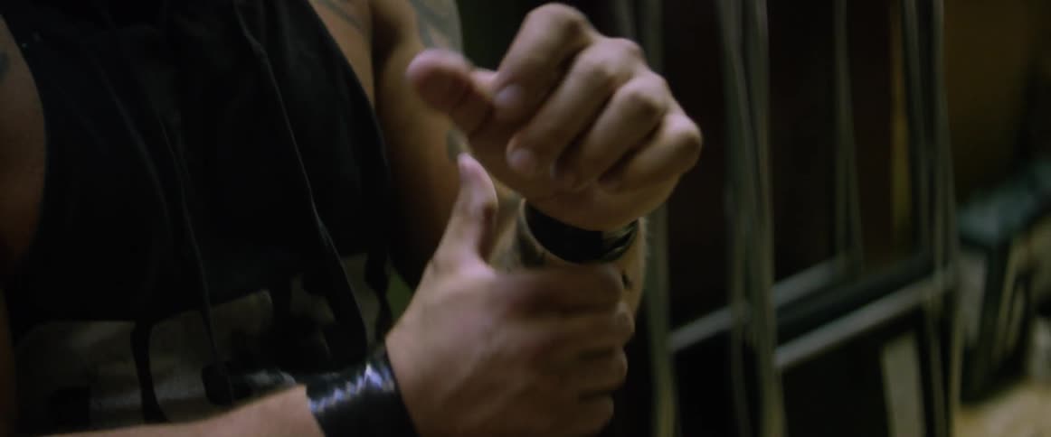 A man wraps tape on his wrists