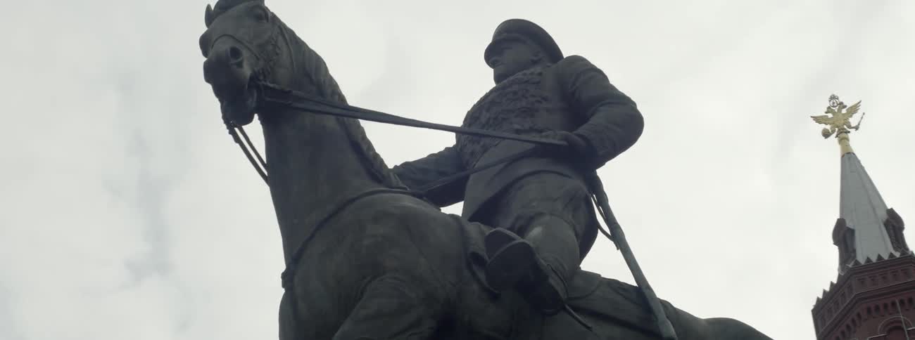 A statue of a man riding a horse towers above