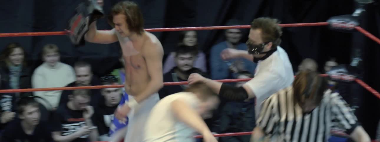Group of men fighting in a ring