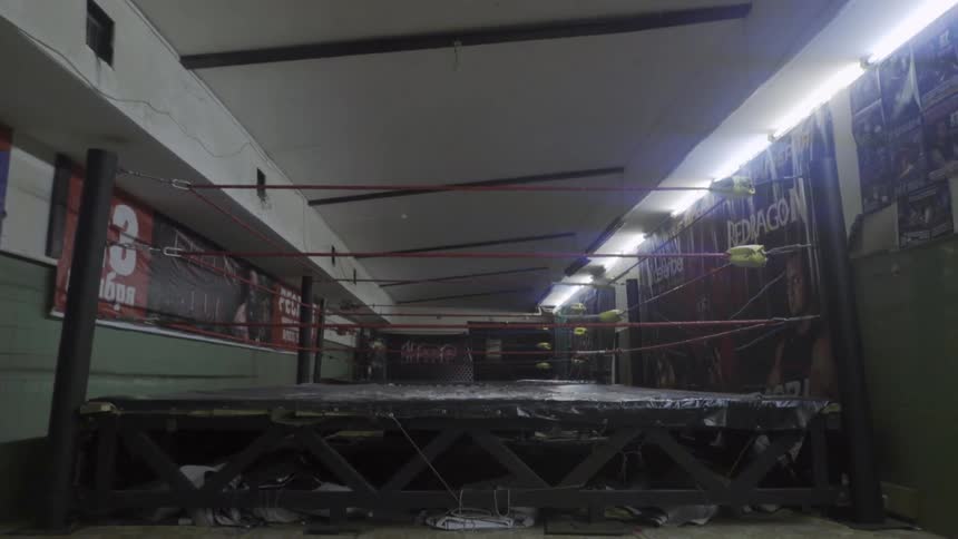 A wrestling ring stands in a gym