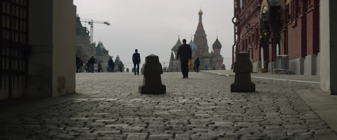 People are walking down a cobblestone street
