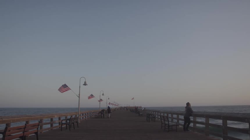 People standing on the ventura pier at sunset
