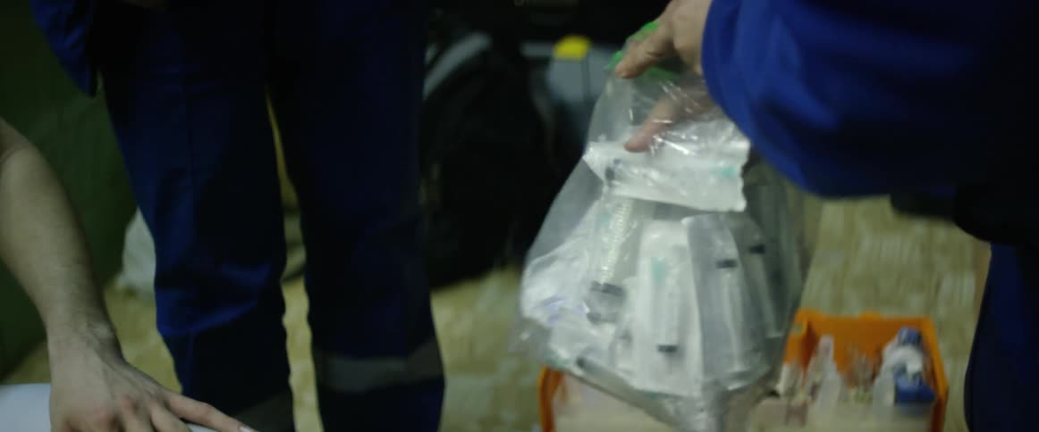 A person is filling a bag with items