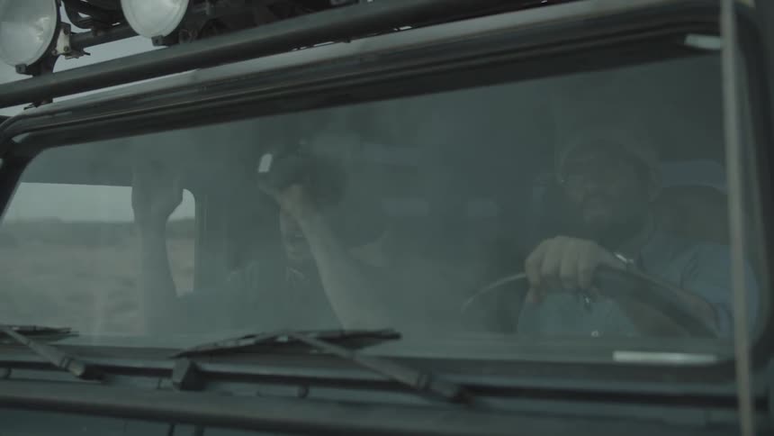 Two men ride in a vehicle