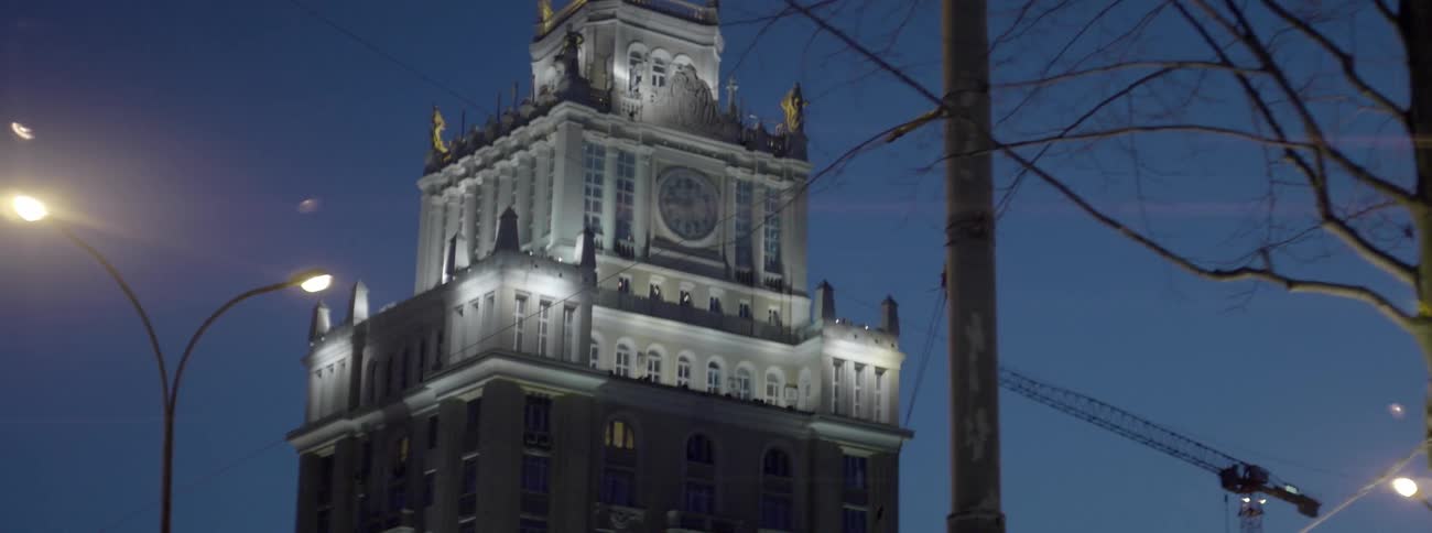 A tall tower has lights lining the top at dawn