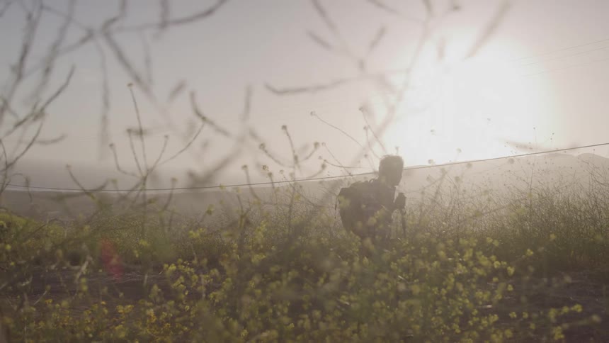 The man is hiking on a foggy day