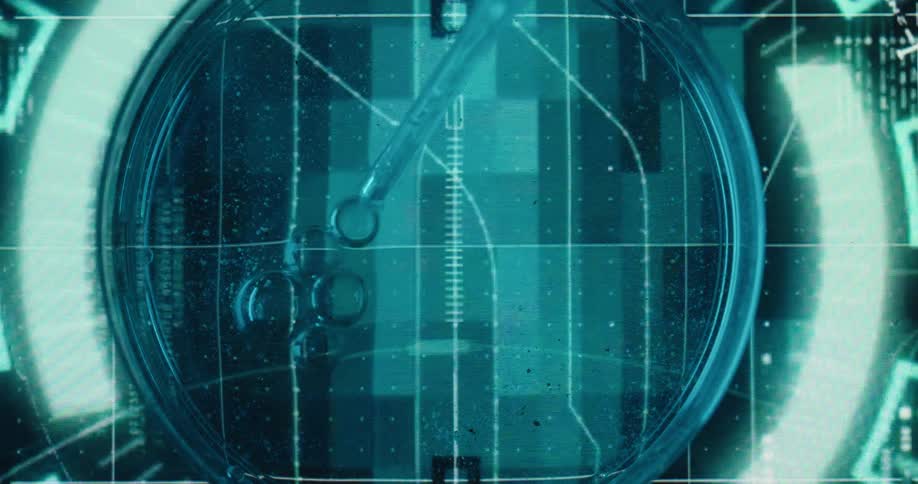 Close up of a liquid sample dropped with a dropper into a petri dish placed on a futuristic screen