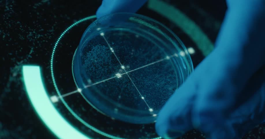 Close up of a petri dish with a liquid sample placed by a person on a futuristic screen for analysis