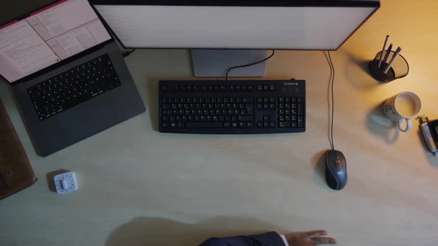 Man working in an office wakes from a timed nap and starts working on his computer