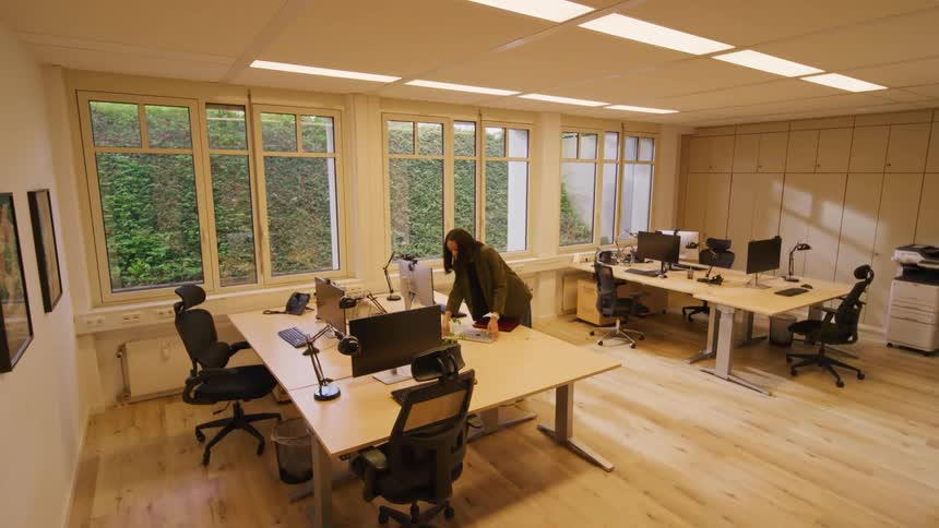 The woman turns the lights on in the office